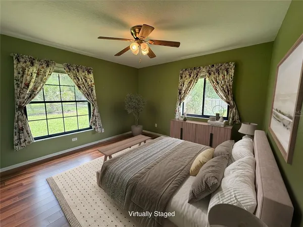 a bed sitting in a bedroom next to a window