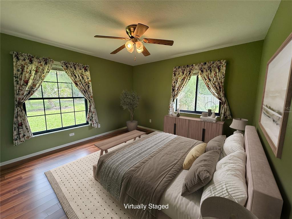 19260 Northwest 88th Avenue Road Reddick, FL 32686 - Photo 16 of 41 a bed sitting in a bedroom next to a window