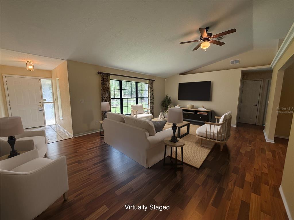 19260 Northwest 88th Avenue Road Reddick, FL 32686 - Photo 3 of 41 a living room with furniture a ceiling fan and a rug