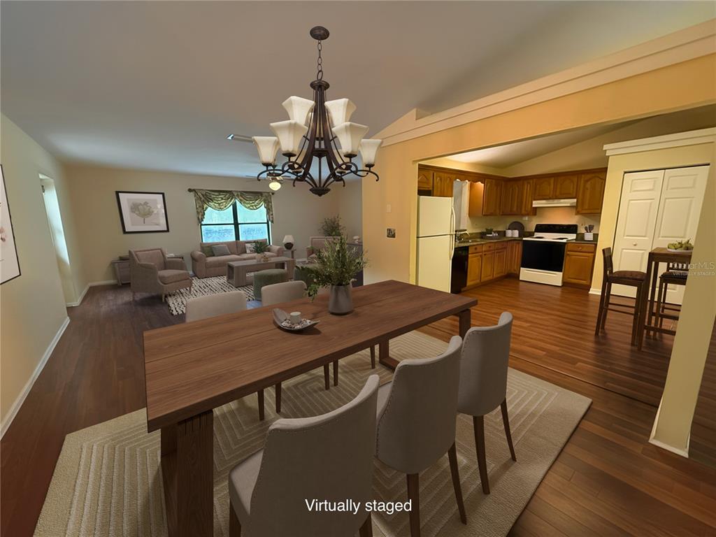 19260 Northwest 88th Avenue Road Reddick, FL 32686 - Photo 5 of 41 a view of a dining room with furniture and wooden floor