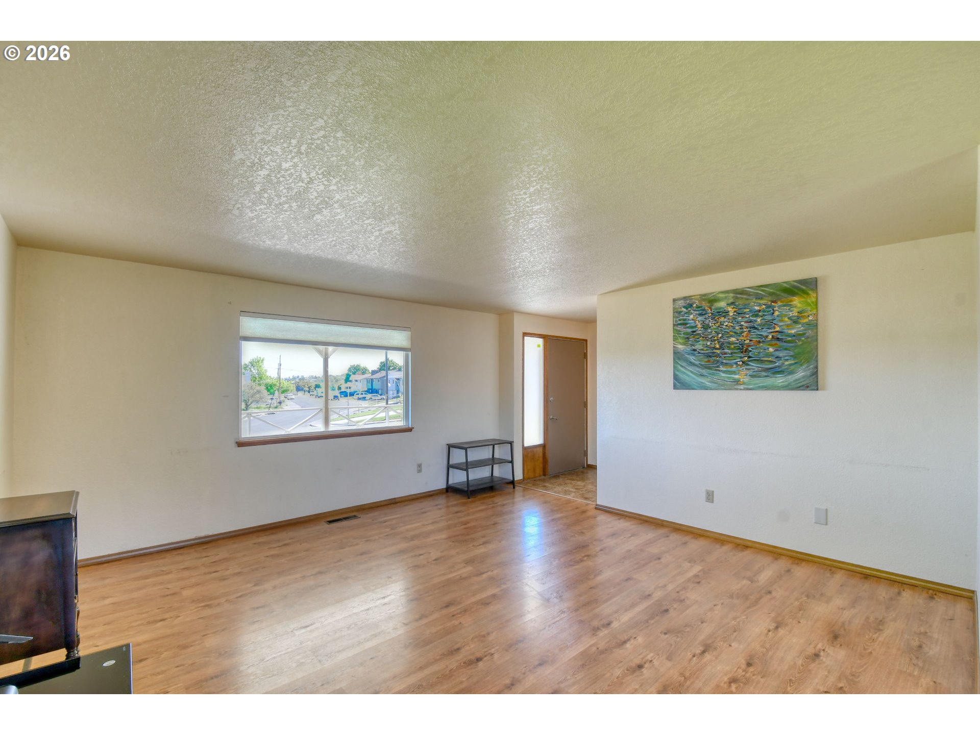 1107 Southwest 23rd Street Pendleton, OR 97801 - Photo 7 of 42 an empty room with wooden floor and windows
