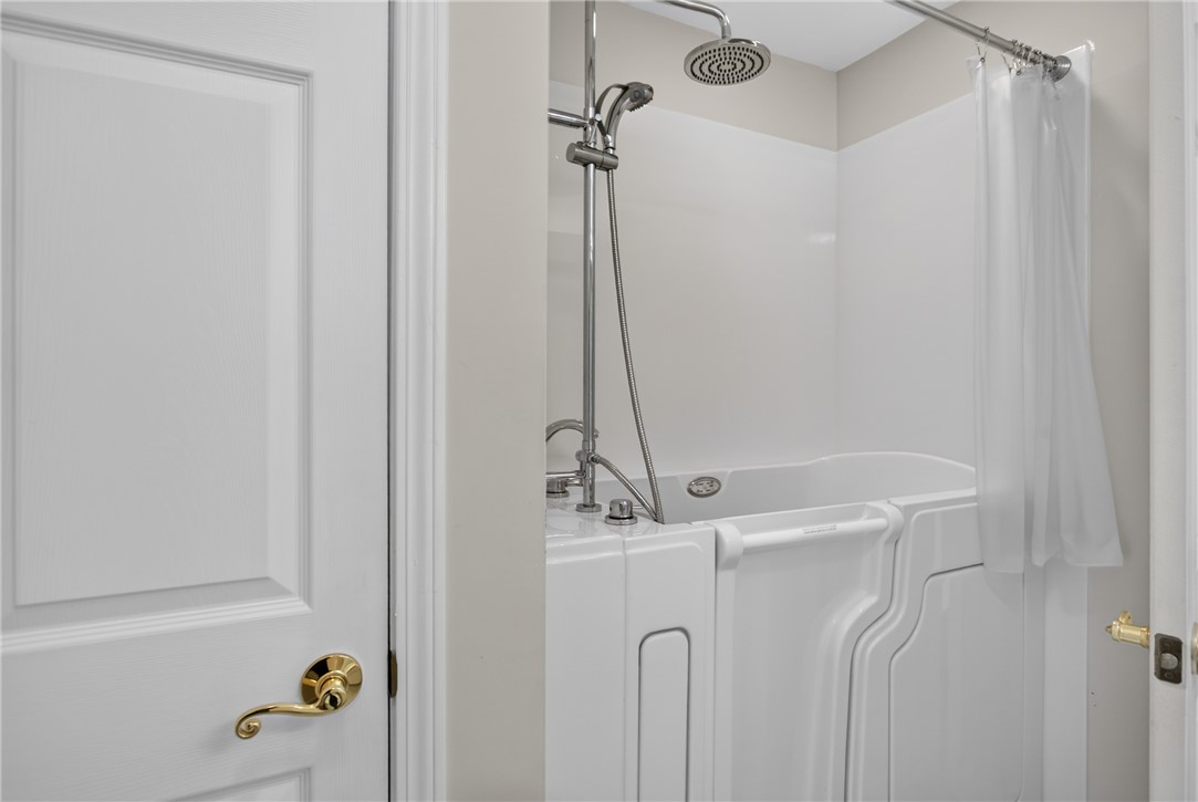 134 Life Style Lane Anderson, SC 29621 - Photo 16 of 44 Accessible walk-in tub with a modern rain showerhead offers comfort and safety.