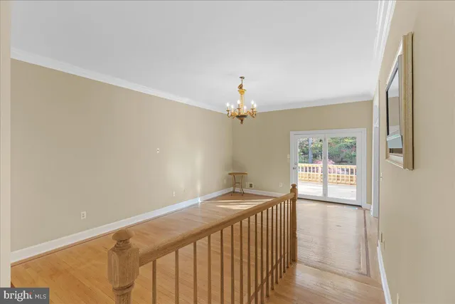 a view of a livingroom with wooden floor a chandelier