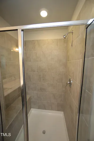 a bathroom with a shower and a bath tub