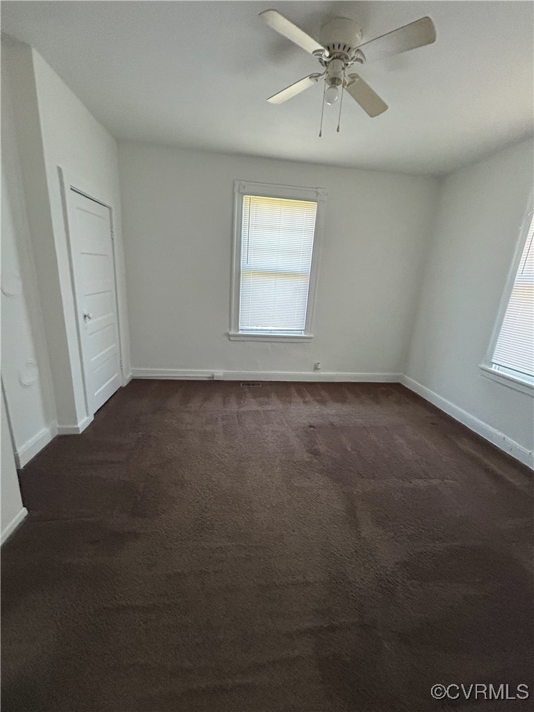 2307 Wright Avenue Richmond, VA 23224 - Photo 24 of 26 an empty room with a chandelier fan and windows