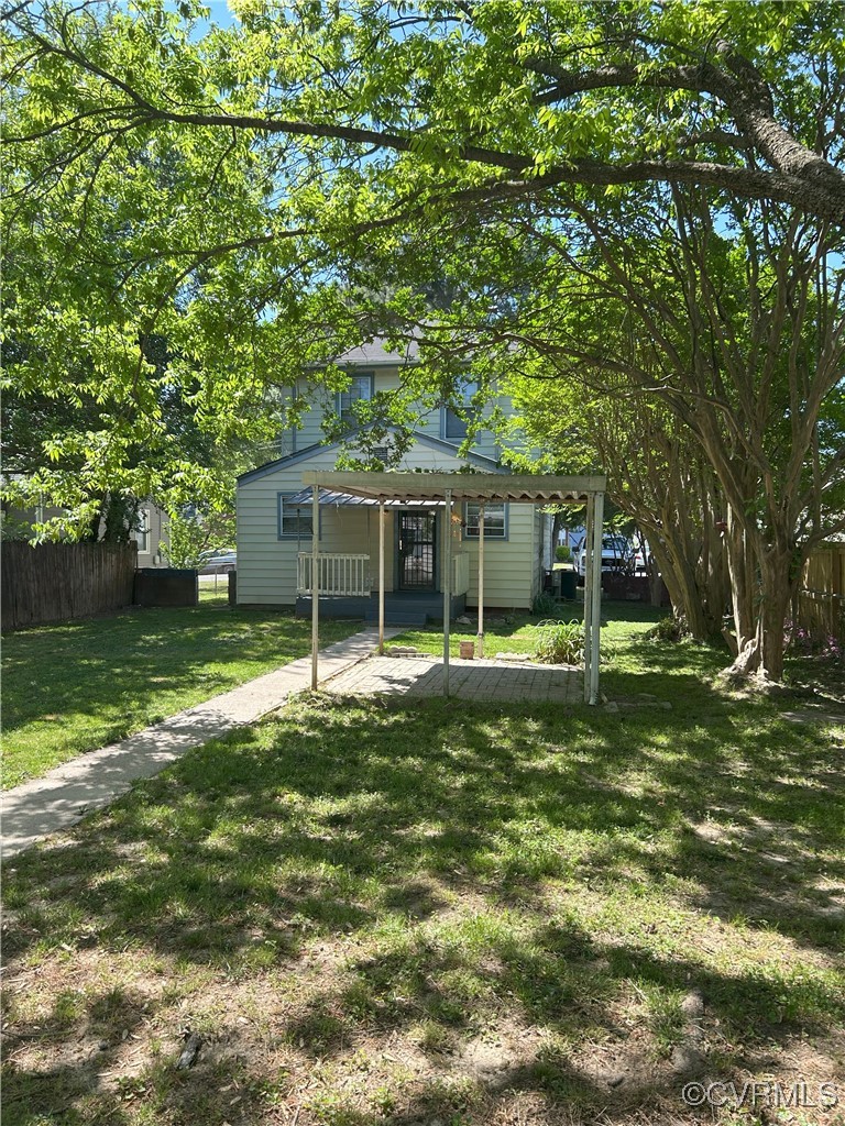 2307 Wright Avenue Richmond, VA 23224 - Photo 5 of 26 a front view of a house with a garden