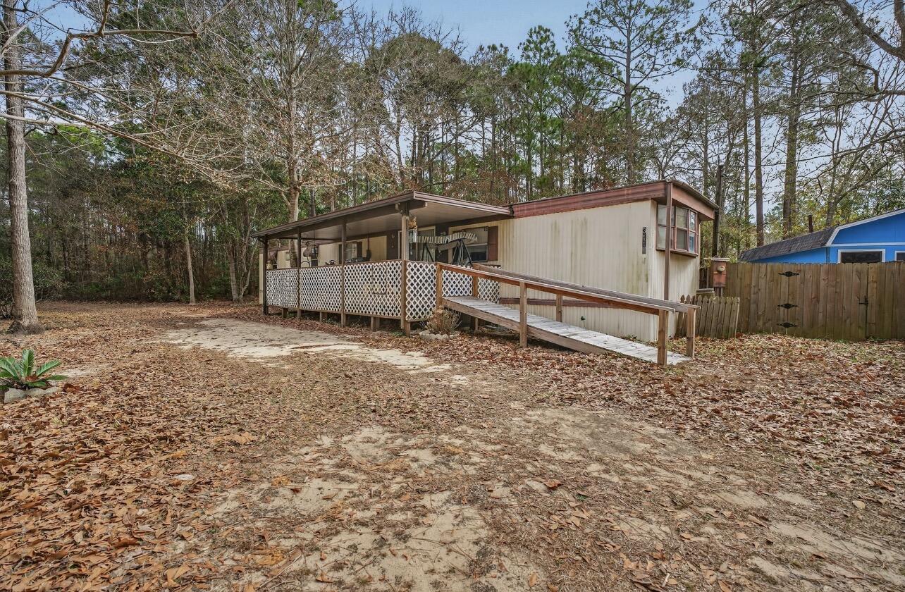 3116 Wells Beach Road Navarre, FL 32566 - Photo 5 of 6 a house with trees in the background