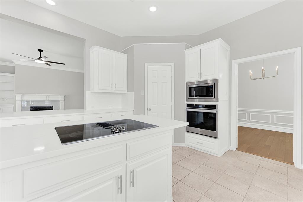 3500 Neiman Road Plano, TX 75025 - Photo 15 of 26 Convenience is key in this kitchen, everything is right where you need it to be for optimal cooking and baking! The built-in oven and microwave are convenient to the cooktop, the pantry and sink.