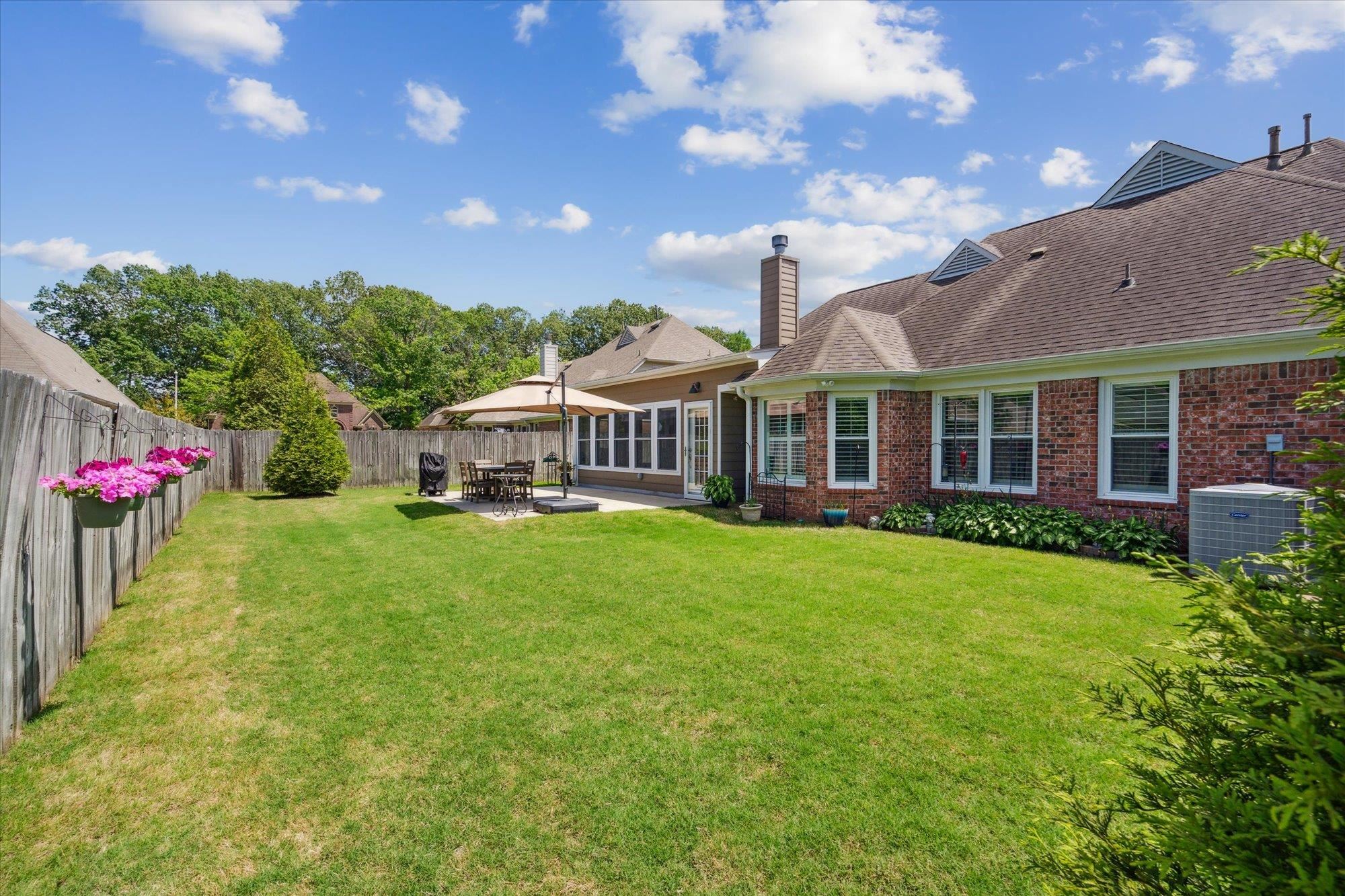 448 Queens Bridge Road Collierville, TN 38017 - Photo 32 of 32 a view of a house with a big yard potted plants and a large tree