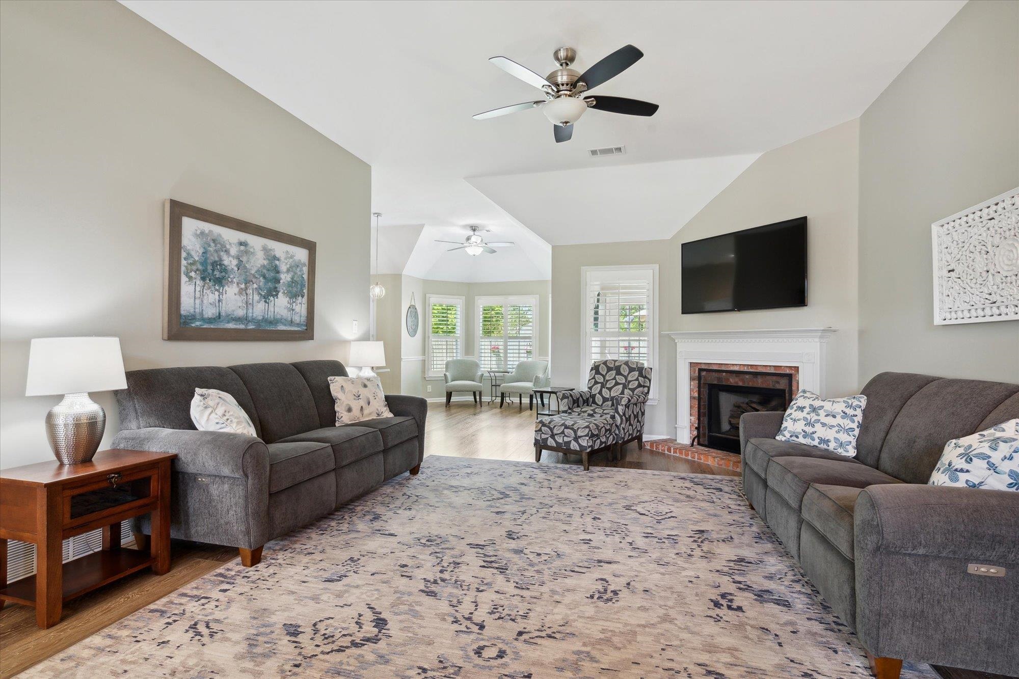 448 Queens Bridge Road Collierville, TN 38017 - Photo 7 of 32 a living room with furniture a fireplace and a flat screen tv