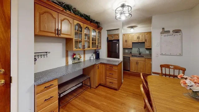 a kitchen with stainless steel appliances granite countertop a stove a sink and a dining table with granite countertops