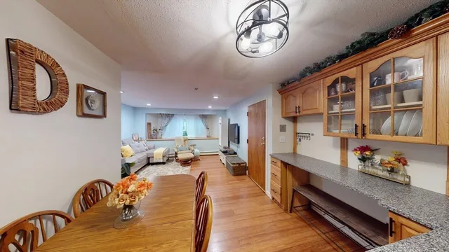 a living room with furniture kitchen view and a window