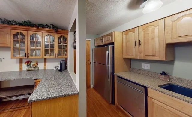 a kitchen with stainless steel appliances granite countertop a granite counter tops and a refrigerator