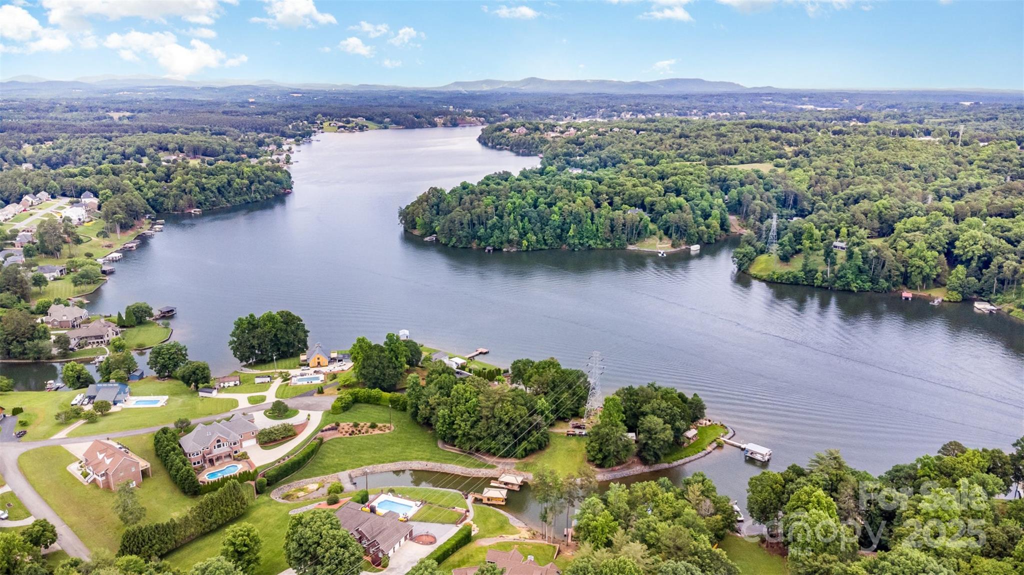 an aerial view of a house with yard and lake view