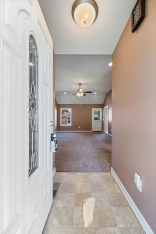 a kitchen with stainless steel appliances granite countertop a refrigerator a sink a stove top oven and a dishwasher