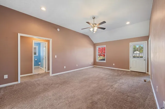 a view of a kitchen with fridge and wooden floor