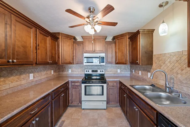 a bathroom with a double vanity sink mirror and shower