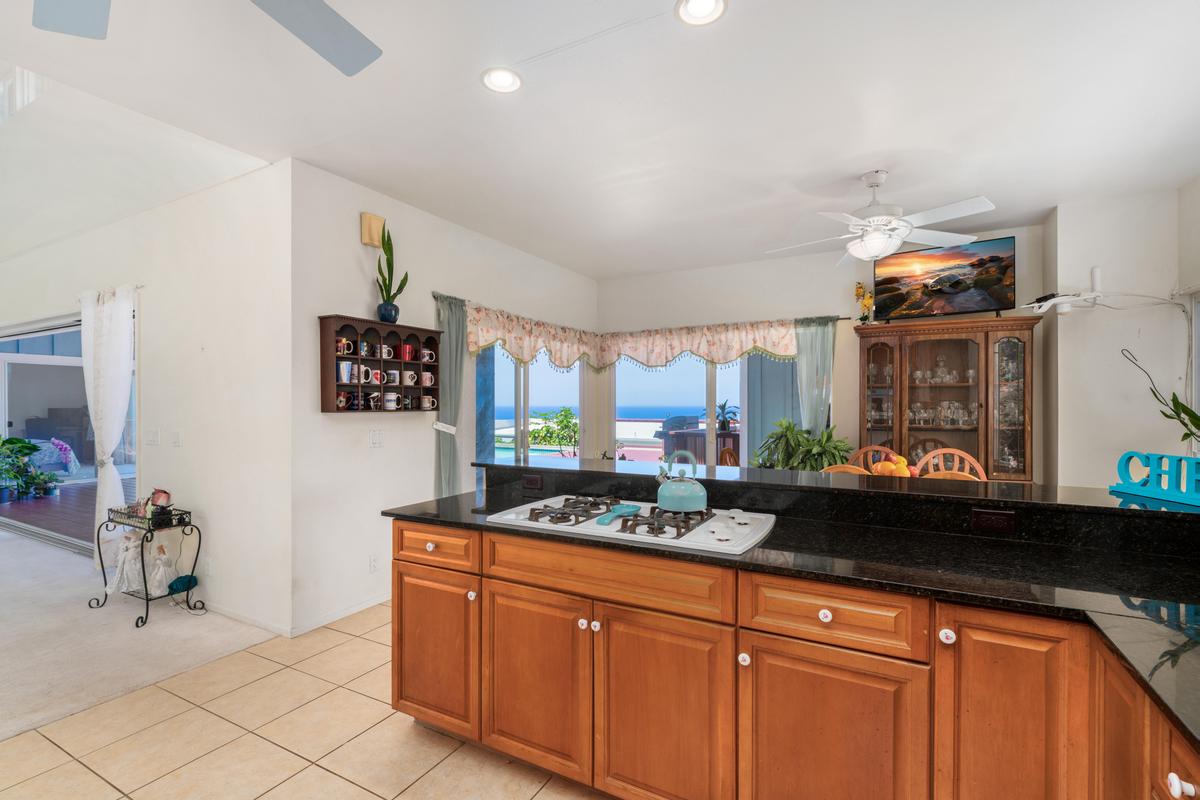 87-404 Kaohe Road Captain Cook, HI 96704 - Photo 12 of 25 a kitchen with stainless steel appliances granite countertop a sink and cabinets