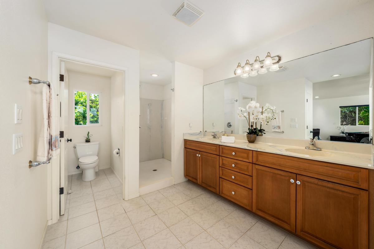87-404 Kaohe Road Captain Cook, HI 96704 - Photo 15 of 25 a spacious bathroom with a double vanity sink toilet and shower