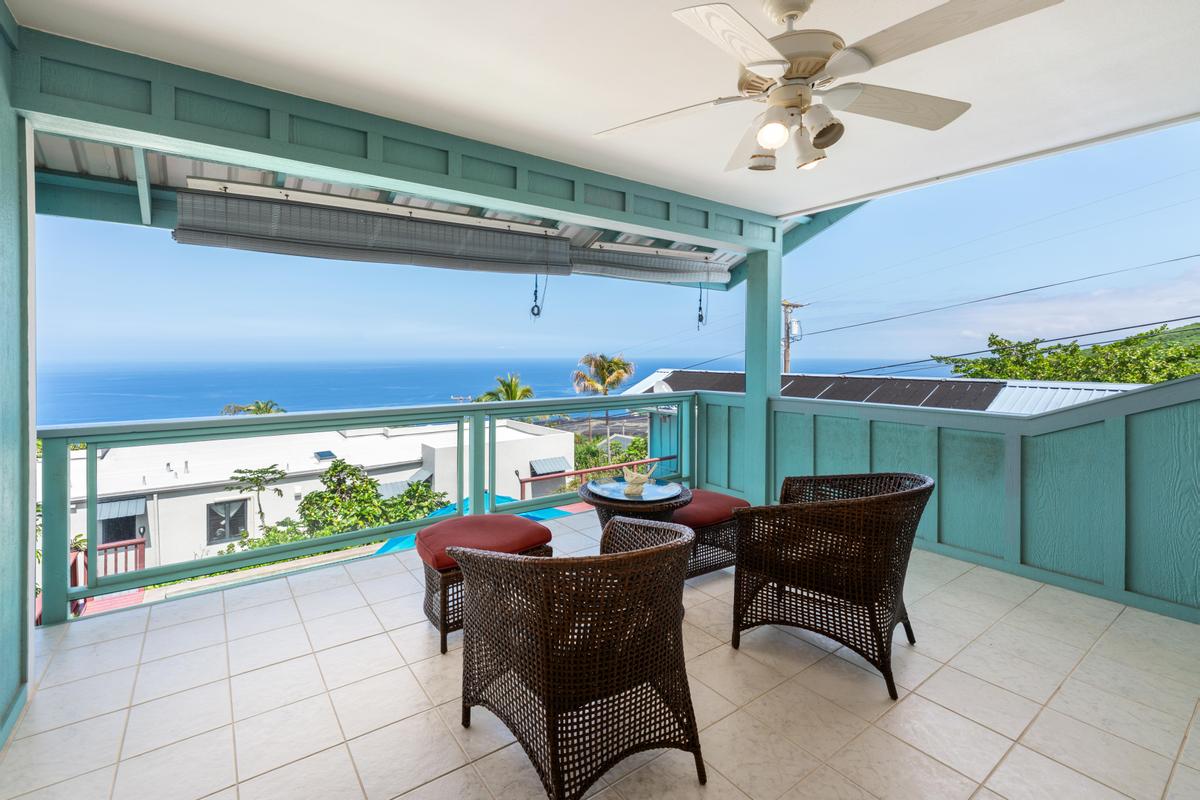 87-404 Kaohe Road Captain Cook, HI 96704 - Photo 19 of 25 a dining room with furniture and a floor to ceiling window