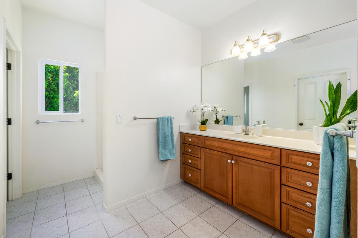 87-404 Kaohe Road Captain Cook, HI 96704 - Photo 21 of 25 a spacious bathroom with a double vanity sink a mirror and a