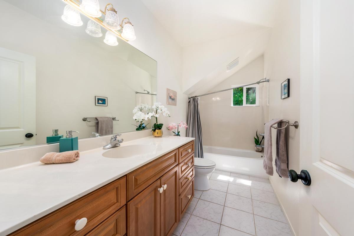 87-404 Kaohe Road Captain Cook, HI 96704 - Photo 23 of 25 a bathroom with a sink a vanity and a mirror