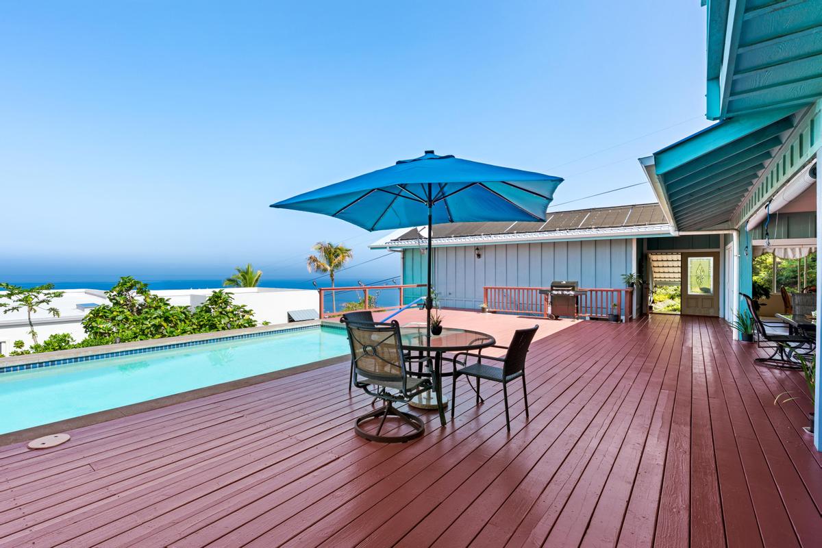 87-404 Kaohe Road Captain Cook, HI 96704 - Photo 5 of 25 a view of a chairs and table on the wooden floor