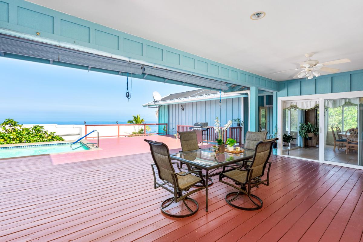 87-404 Kaohe Road Captain Cook, HI 96704 - Photo 6 of 25 a view of a dining room with furniture and wooden floor
