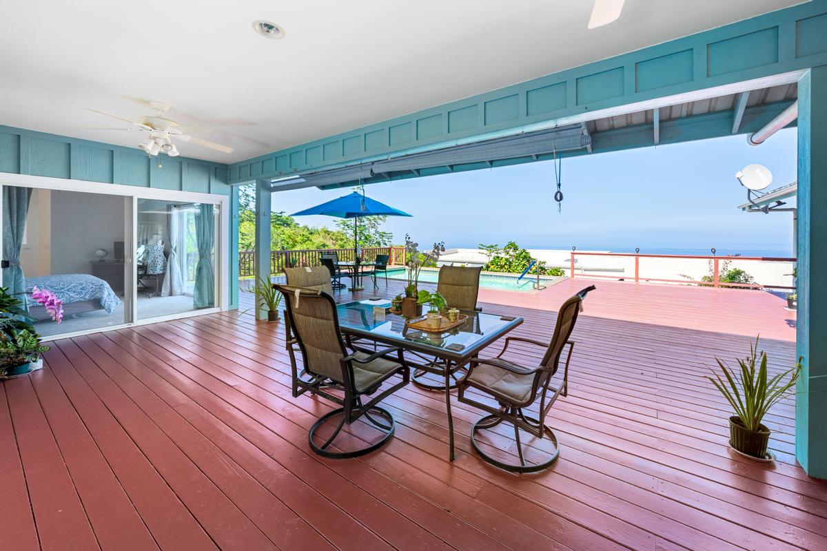 87-404 Kaohe Road Captain Cook, HI 96704 - Photo 7 of 25 a dining room with furniture and wooden floor
