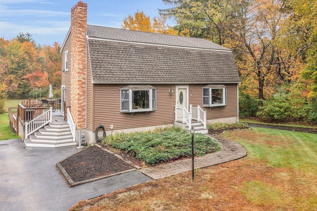91 Chapin Road Hudson, MA 01749 - Photo 1 of 42 a front view of a house with a garden
