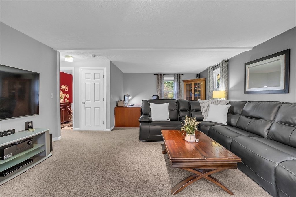 91 Chapin Road Hudson, MA 01749 - Photo 14 of 42 a living room with furniture and a flat screen tv
