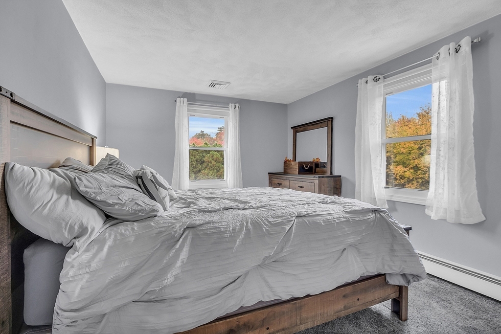 91 Chapin Road Hudson, MA 01749 - Photo 21 of 42 a bedroom with a large bed and a window