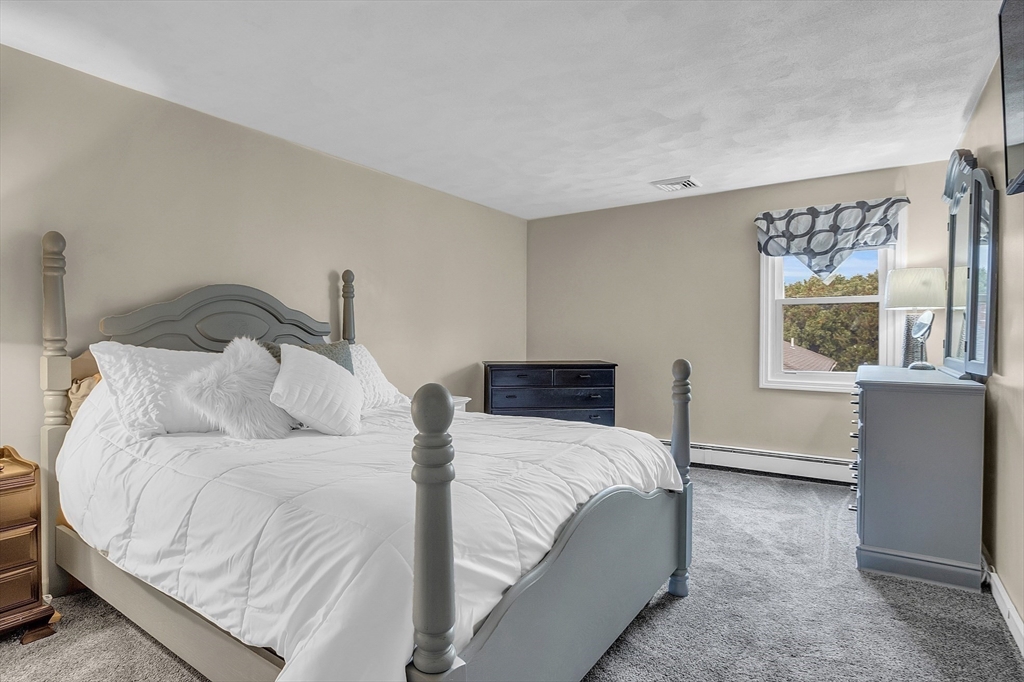 91 Chapin Road Hudson, MA 01749 - Photo 22 of 42 a bedroom with a bed and a window