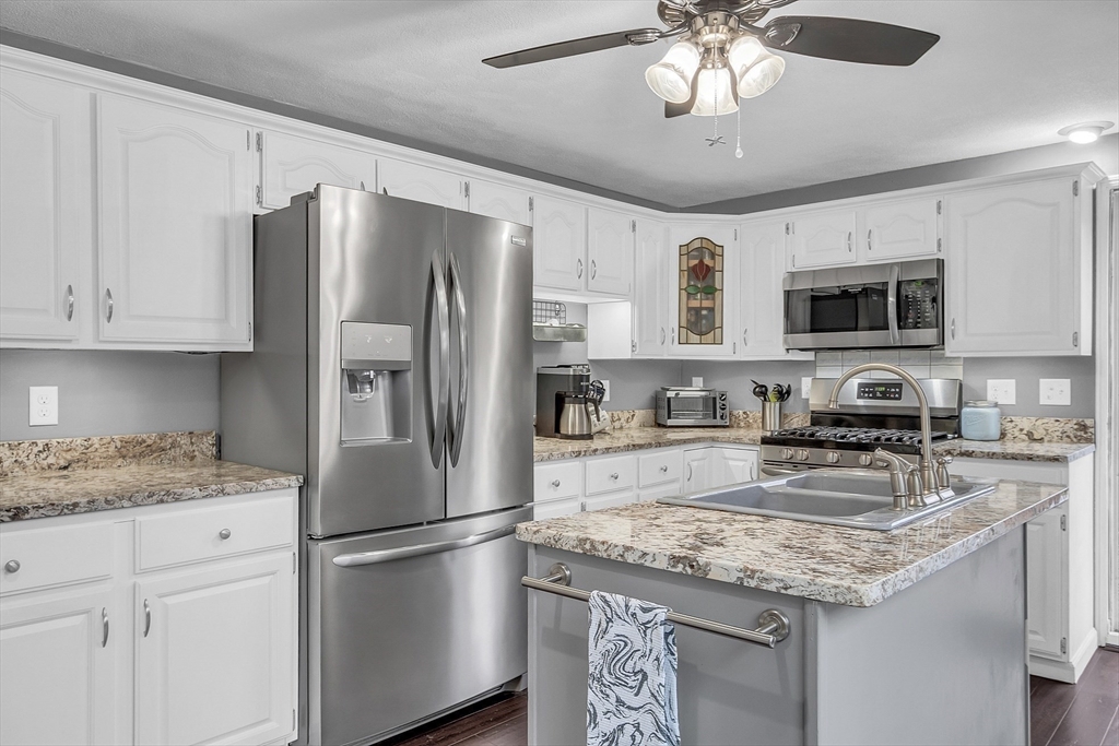 91 Chapin Road Hudson, MA 01749 - Photo 7 of 42 a kitchen with stainless steel appliances granite countertop a refrigerator sink stove microwave and cabinets