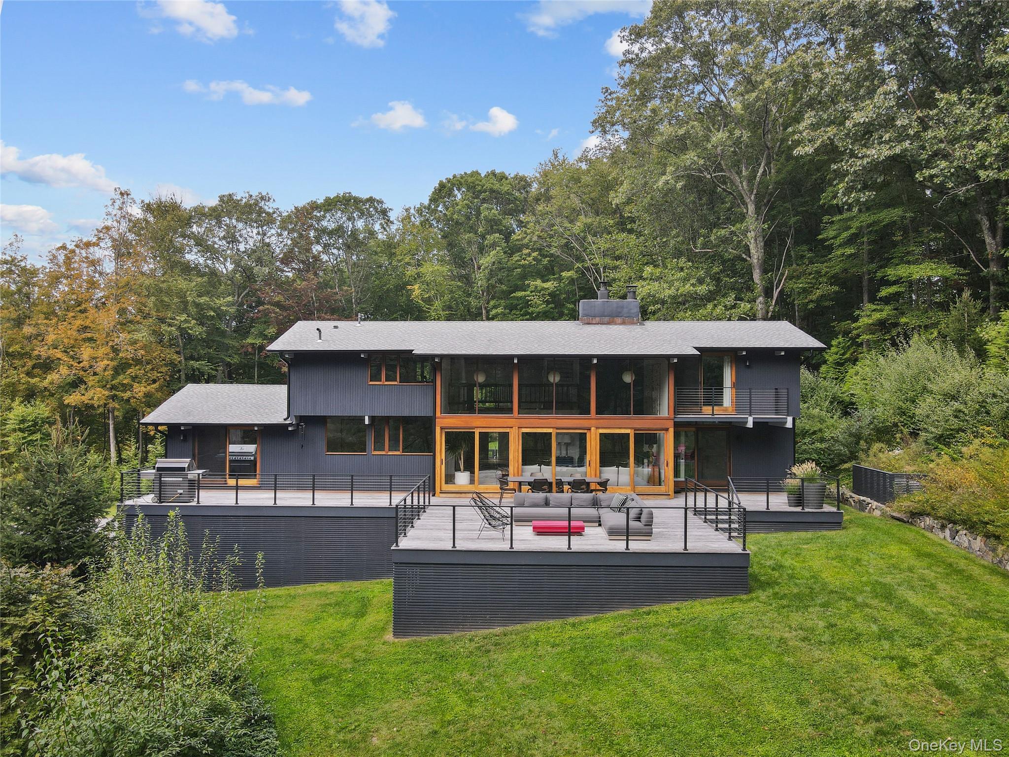 21 Black Spring Road Pound Ridge, NY 10576 - Photo 2 of 26 Back of house featuring oversized Brazilian hardwood deck