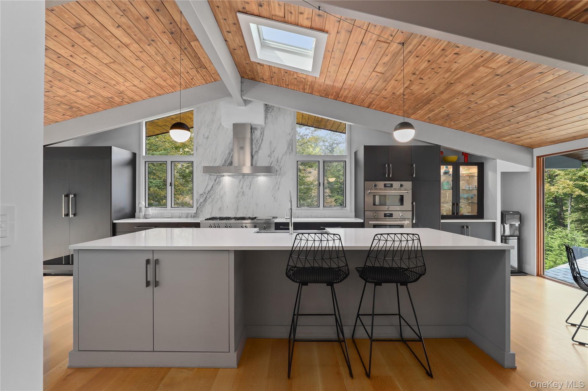 21 Black Spring Road Pound Ridge, NY 10576 - Photo 5 of 26 Kitchen with Bilotta cabinets, Bertazzoni stove, white quartz island and Calcutta gold marble backsplash
