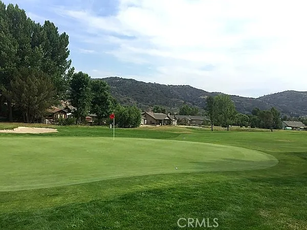 a view of grassy field with mountain