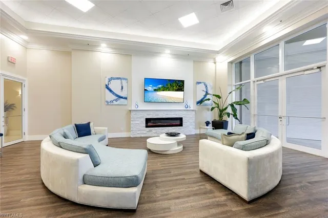 a lobby with furniture and a potted plant