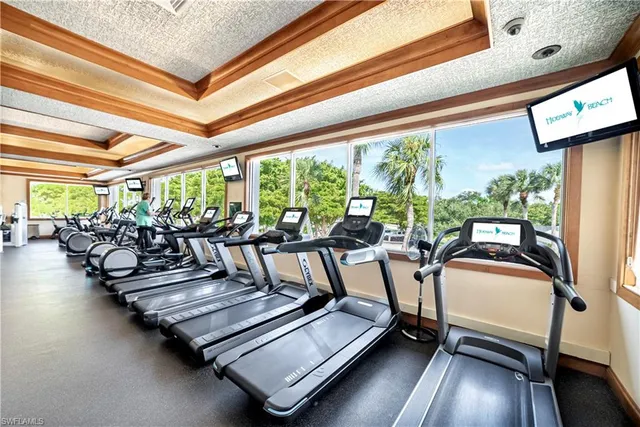 a view of a swimming pool with a table and chairs under an umbrella