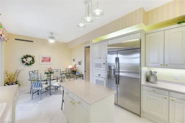 a kitchen with a sink a counter top space cabinets and stainless steel appliances