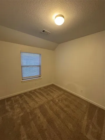 an empty room with a empty space and windows