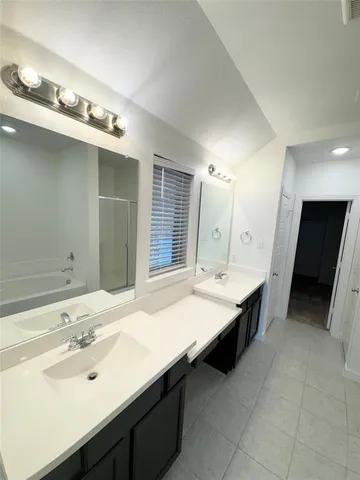 a bathroom with a double vanity sink a and a mirror