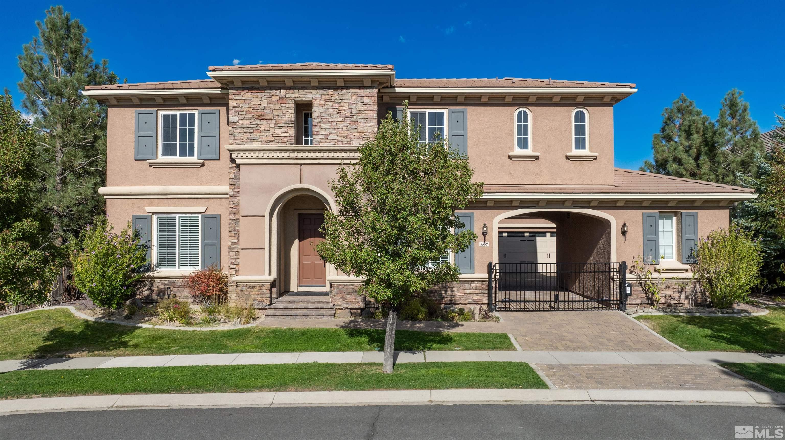 1880 Laurel Ridge Drive Reno, NV 89523 - Photo 1 of 40 a front view of a house with a garden