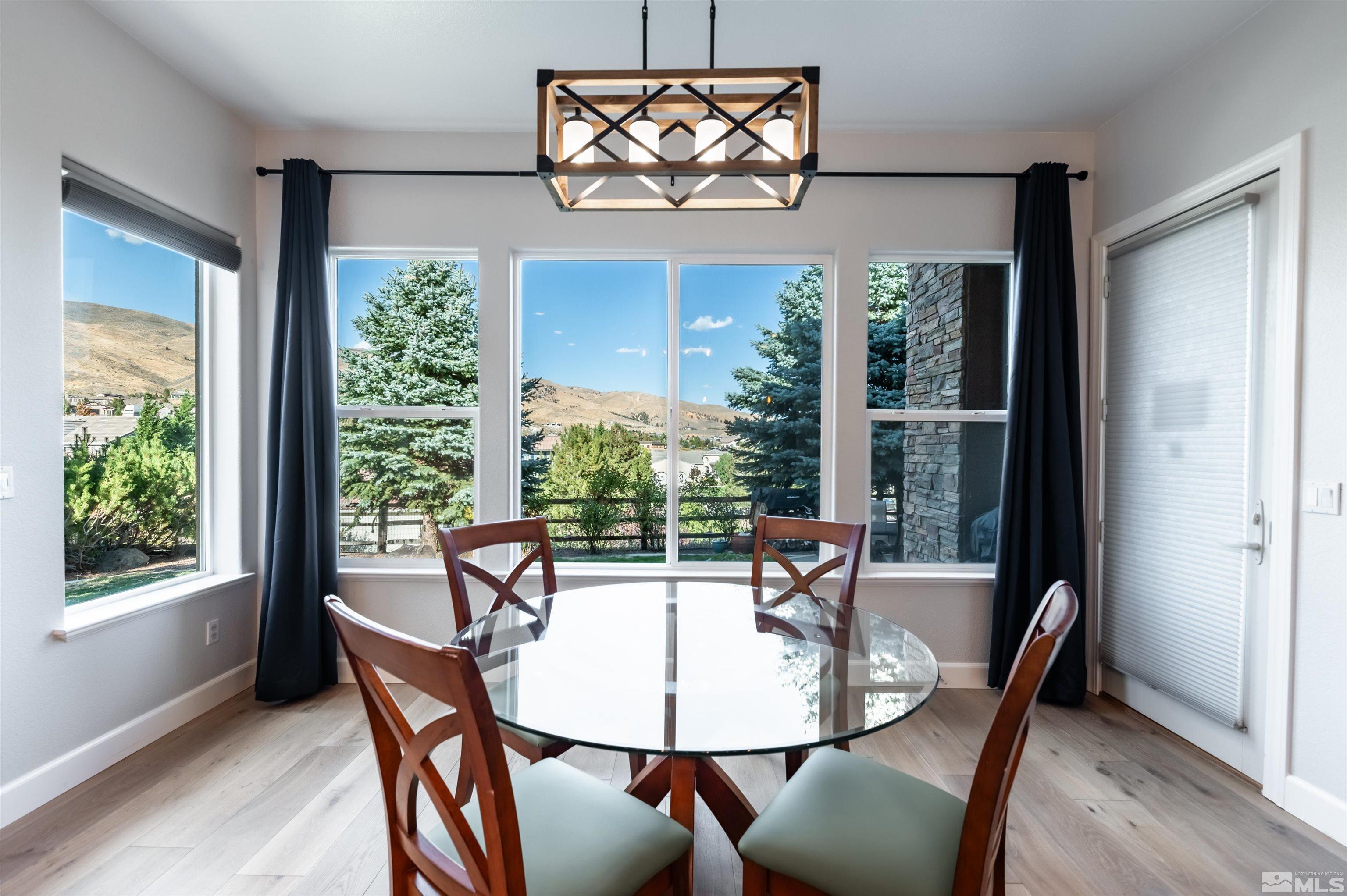 1880 Laurel Ridge Drive Reno, NV 89523 - Photo 11 of 40 a view of a dining room with furniture a chandelier and wooden floor