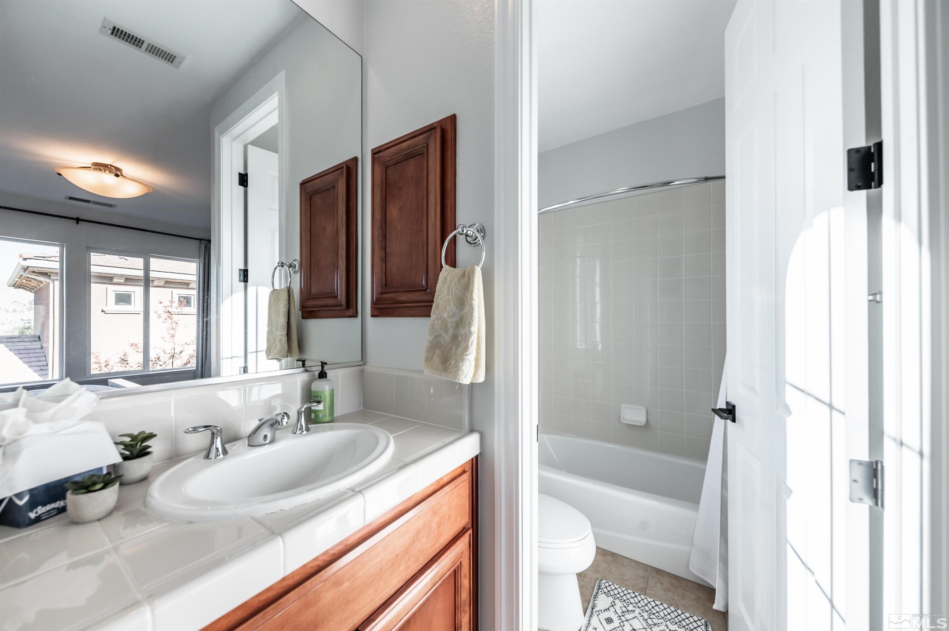 1880 Laurel Ridge Drive Reno, NV 89523 - Photo 28 of 40 a bathroom with a granite countertop sink toilet and shower