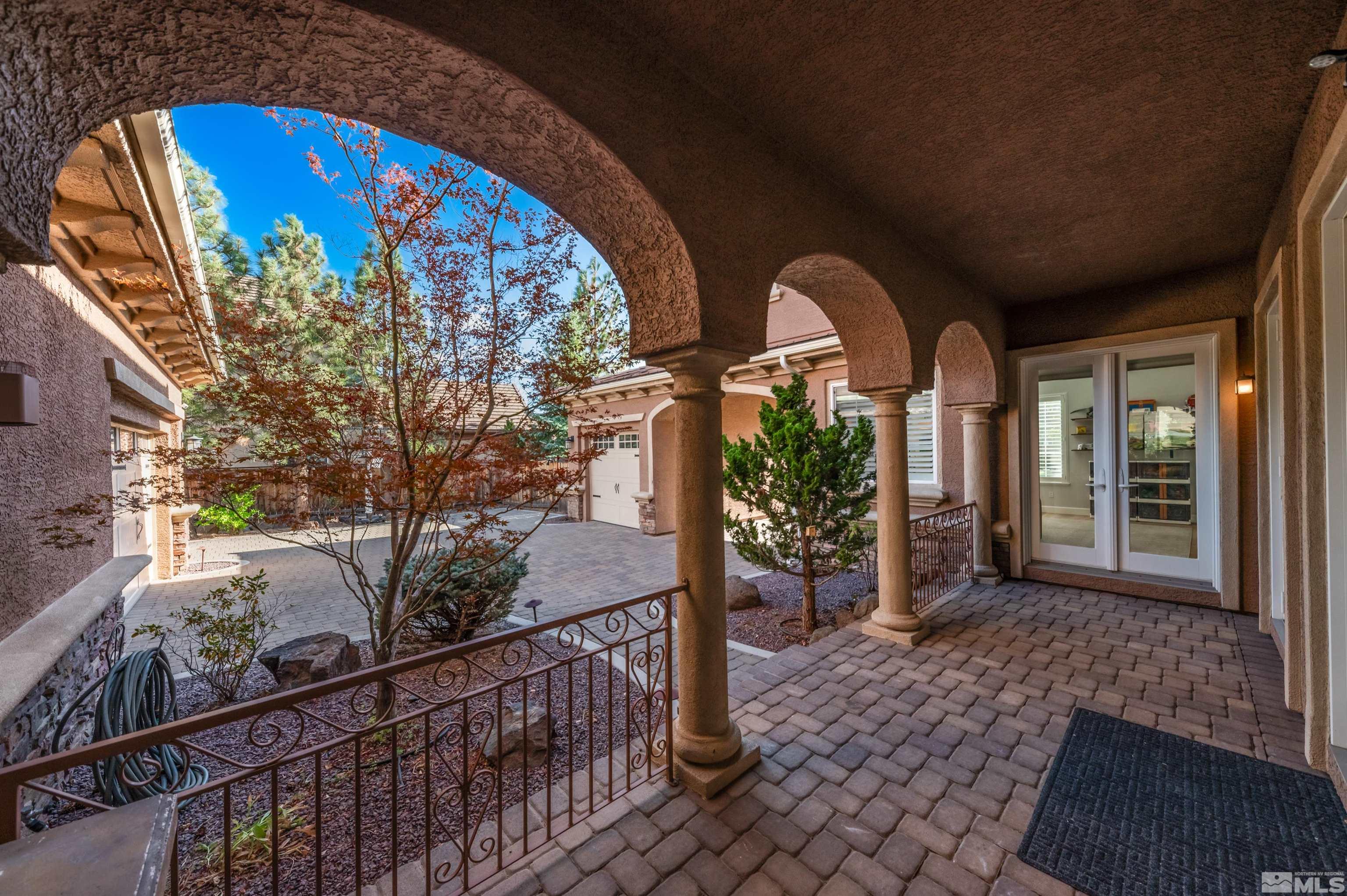 1880 Laurel Ridge Drive Reno, NV 89523 - Photo 3 of 40 a view of a house with large windows and a wooden fence