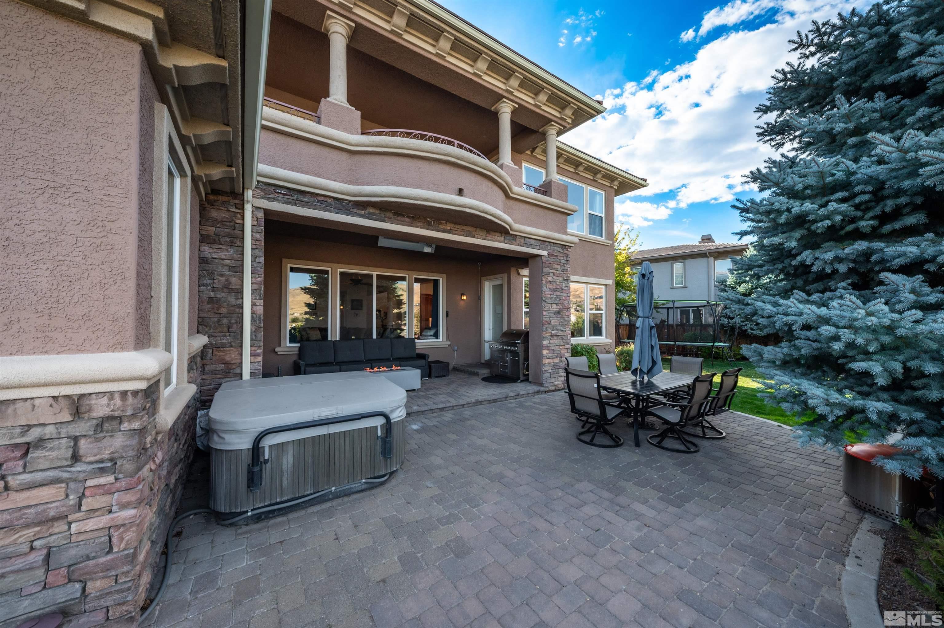 1880 Laurel Ridge Drive Reno, NV 89523 - Photo 33 of 40 a view of a patio with table and chairs and a barbeque