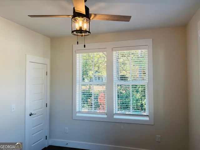 a view of a room with a window and chandelier