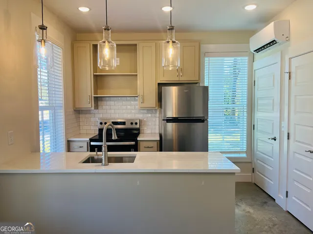 a kitchen with refrigerator cabinets and wooden floor