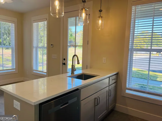 a kitchen that has a sink and a large window
